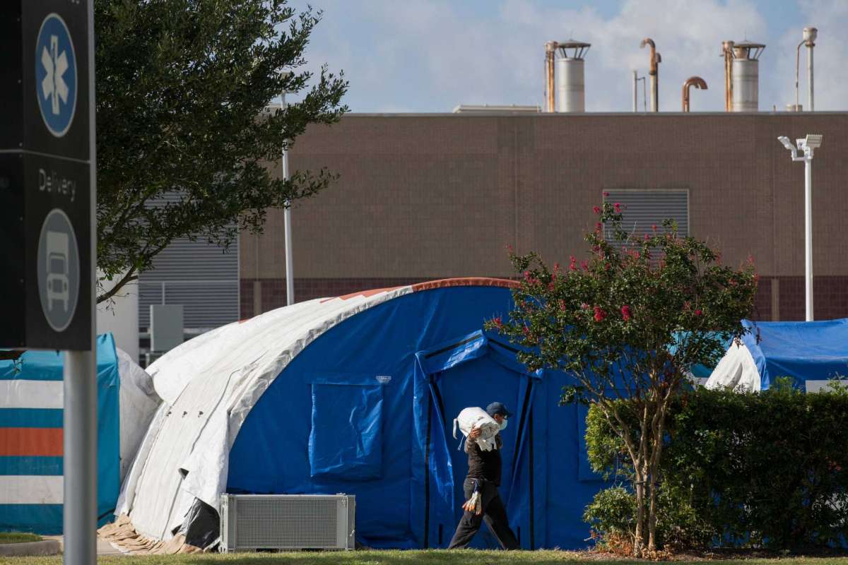 11A construction crew works to setup tents in case of overflow COVID-19 and ICU patients outside Lyndon B. Johnson Hospital on Monday, Aug. 9, 2021, in Houston